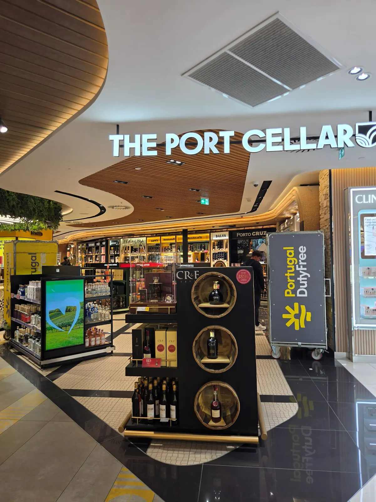 The entrance to The Port Cellar, the port wine section of Lisbon Airport duty free, with a Portuguese brandy display