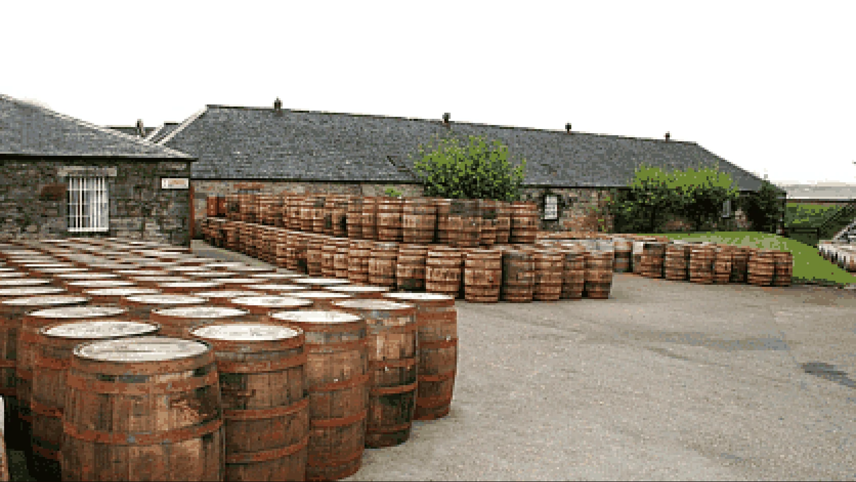 16-bit graphics recreate multiple oak casks waiting for their first fill in the distillery yard